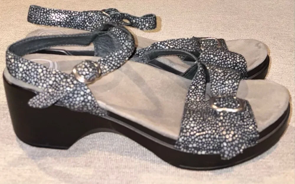 Dansko sandals, specifically the Sandi model featuring a black and white speckle